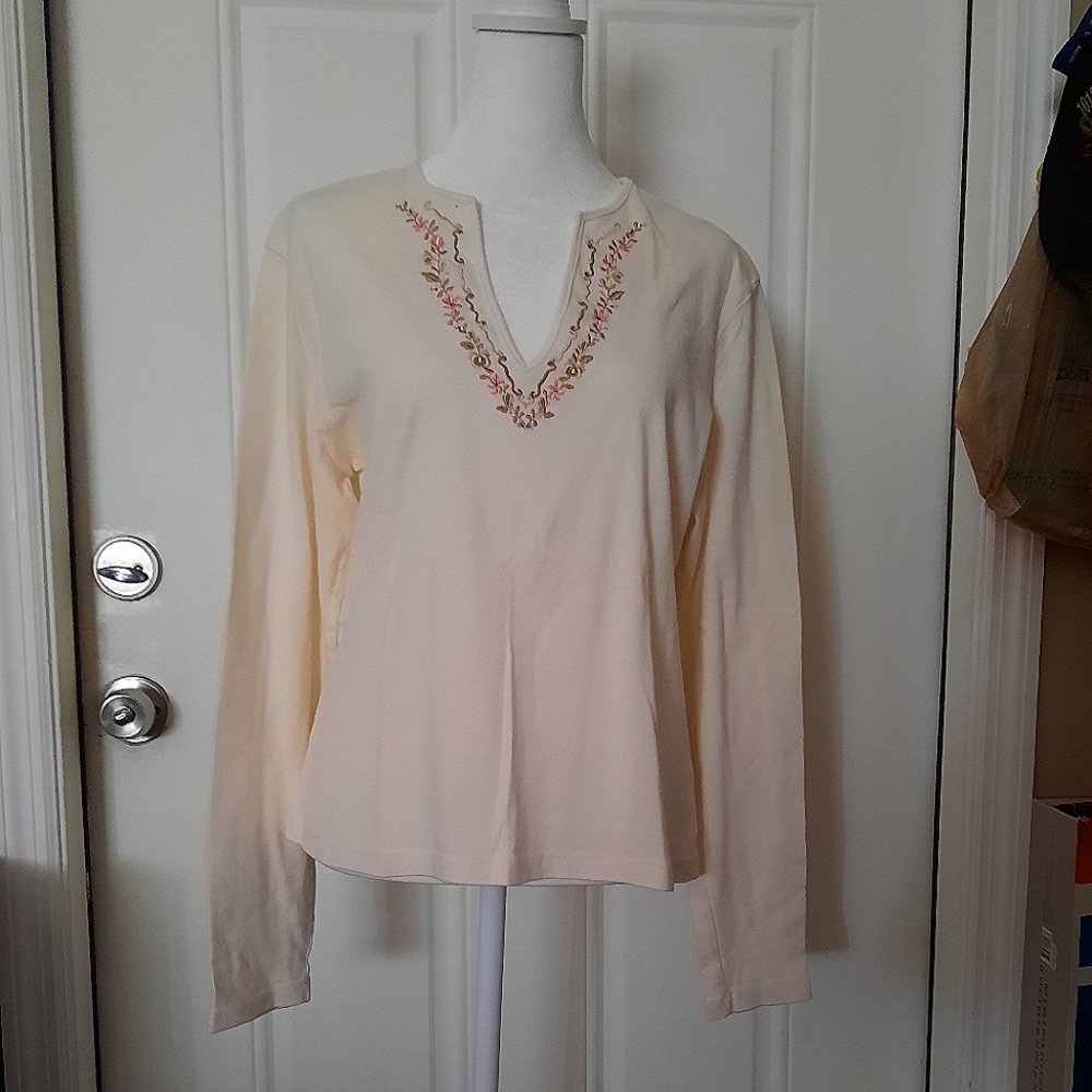 M cream colored, long sleeve blouse.